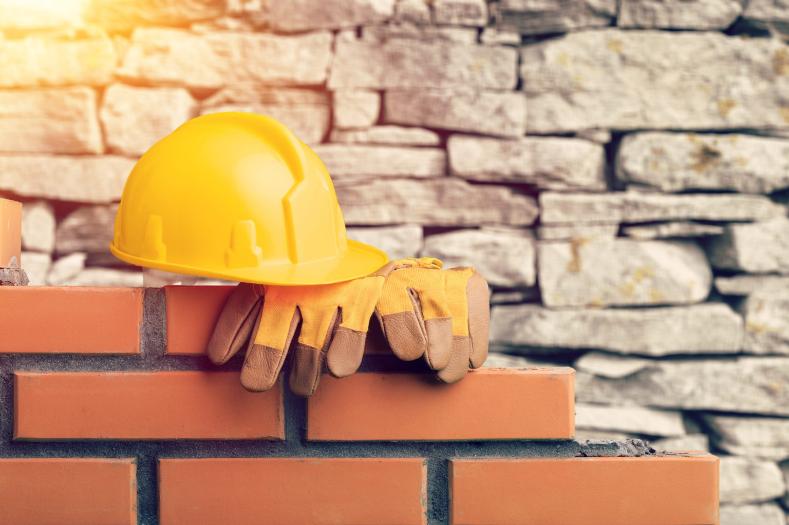 Yellow helmets on wall on blurred background